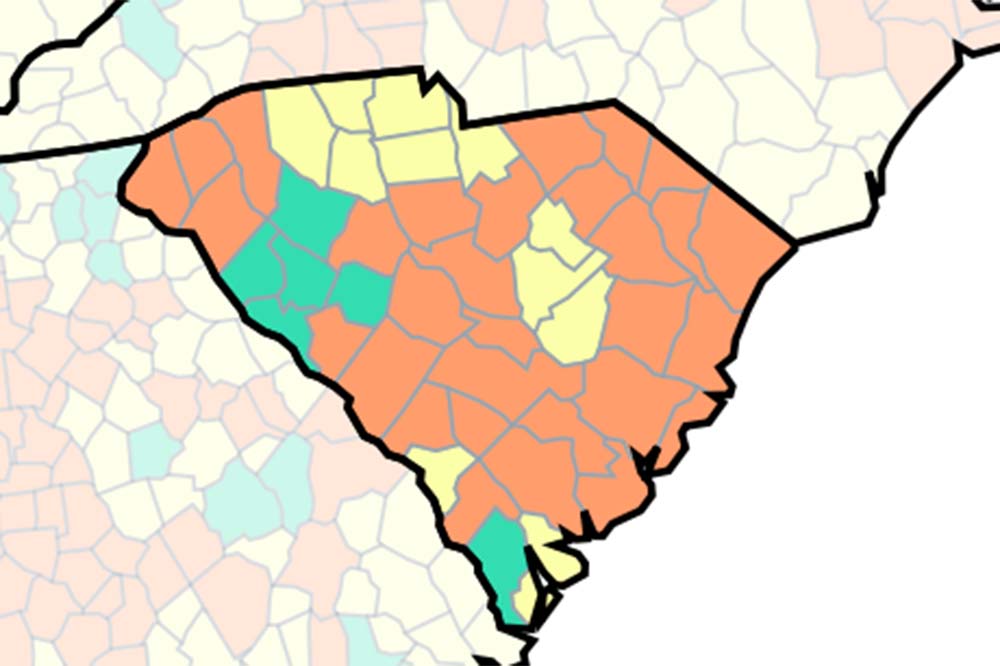 Map of South Carolina with most of the state colored orange. Small parts are green or yellow.