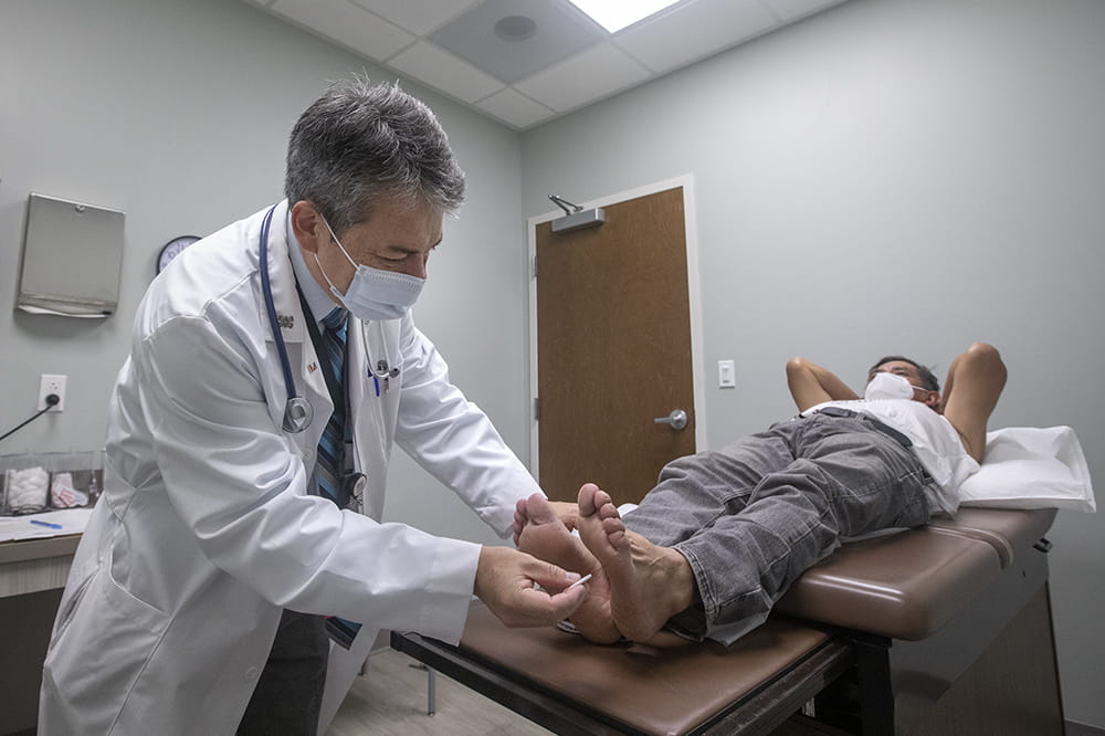 Dr. Hermes Florez examines Octavio Carrillo-Lopez, checking for neuropathy, at the Barrier Islands Free Medical Clinic on Johns Island. 
