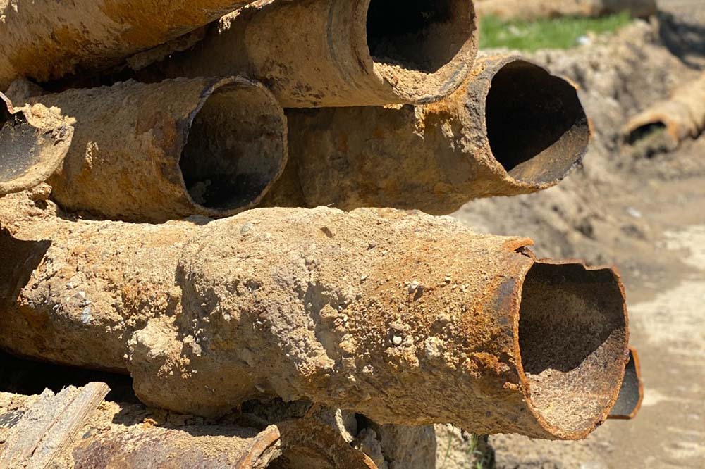Brown colored pipes piled up in Flint, Michigan.