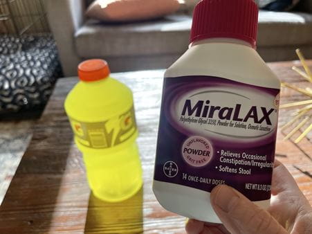 A close up view of the bottle of Miralax showing it's 14 doses, all of which Bryce had to take