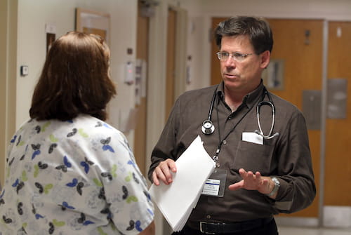 Dr. Patrick Flume talks with Sue Gray, nurse coordinator for Adult Cystic Fibrosis, about one of his patients.