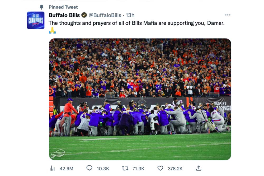 Social media post shows football players kneeling around an injured player.