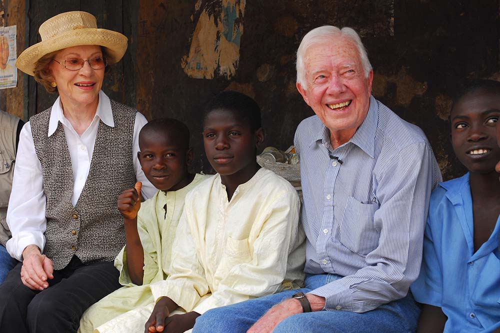 Jimmy and Rosalynn Carter sit with three children in Nigeria.
