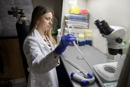 A woman uses lab equipment