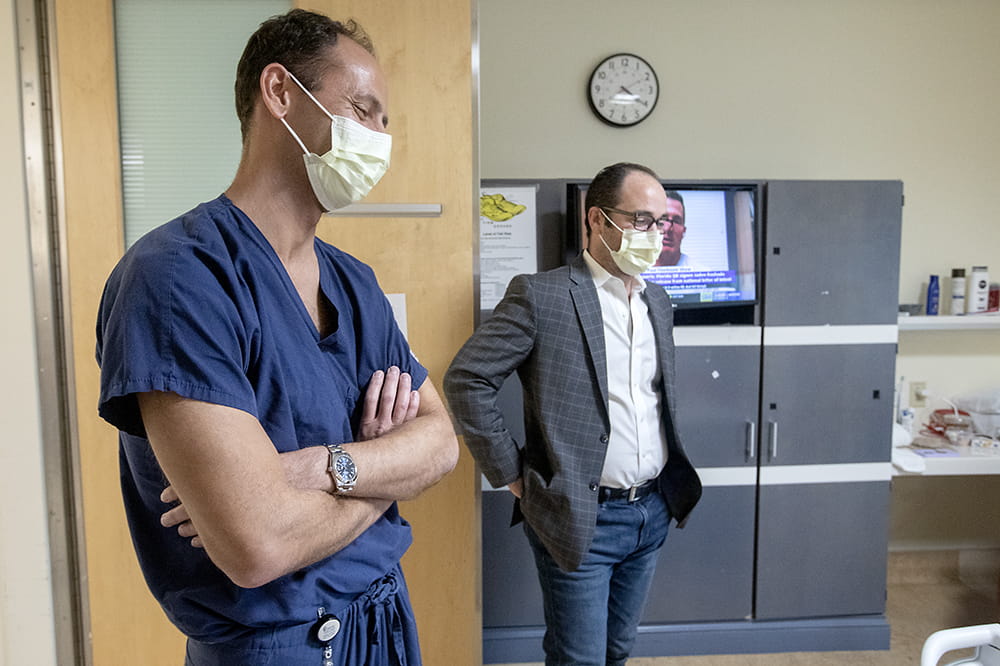 Two surgeons stand in the door to Suttle's hospital room