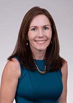 Woman with shoulder length brown hair smiles for her profile photo.