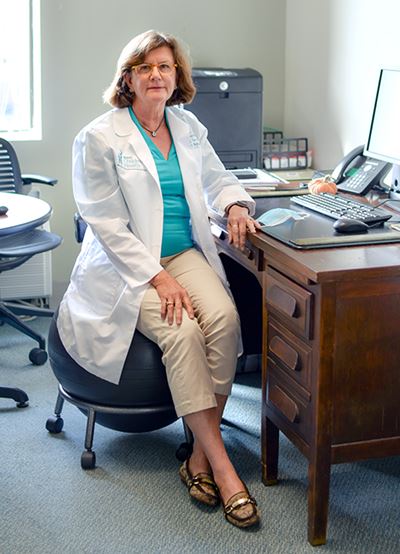 Dr. Janice Key sits at her desk