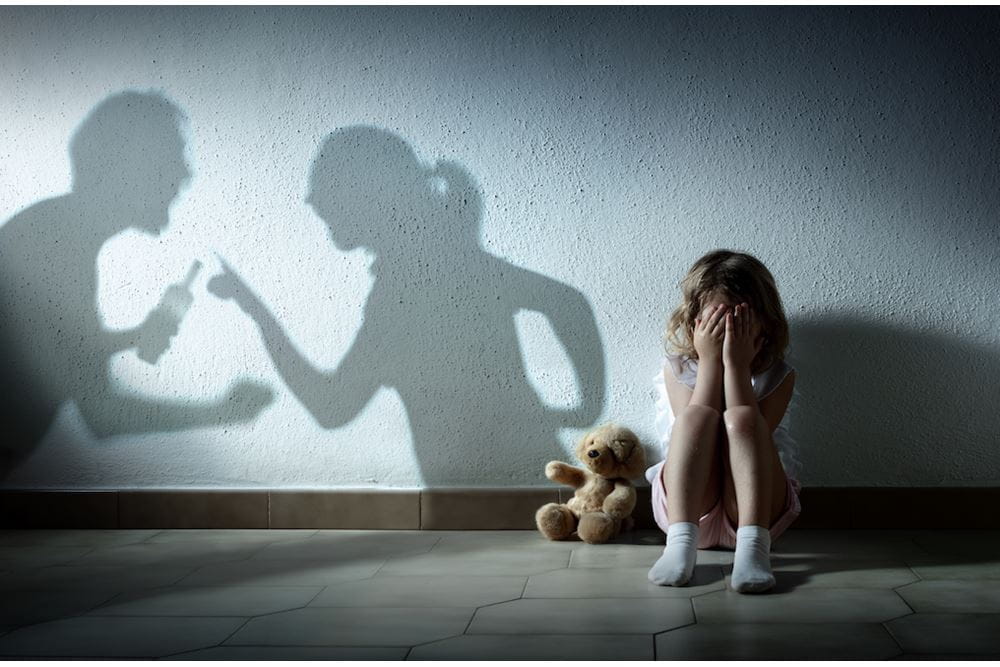 Little Girl Crying With Shadow Of Parents Arguing. Image by RomoloTavani. Licensed from istockphoto.com.