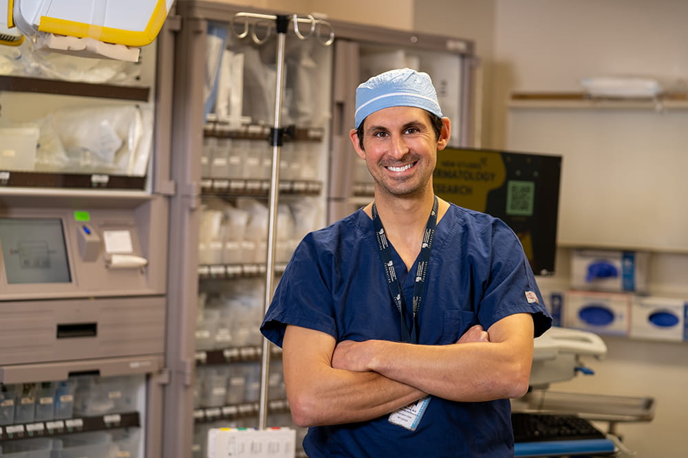 head and neck cancer surgeon Evan Graboyes poses in the operating room