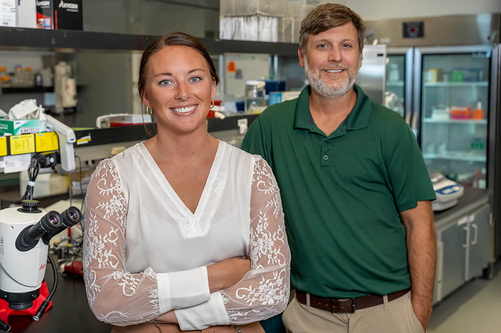 two CAR-T cell researchers pose in a lab at MUSC Hollings Cancer Center