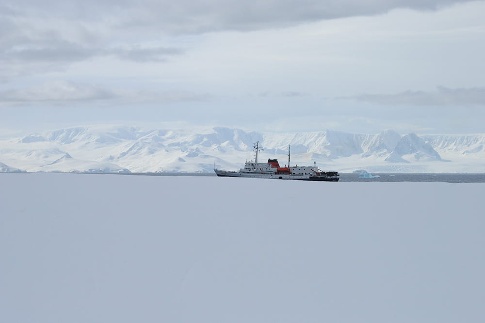 a boat in the sea alongside Antarctica