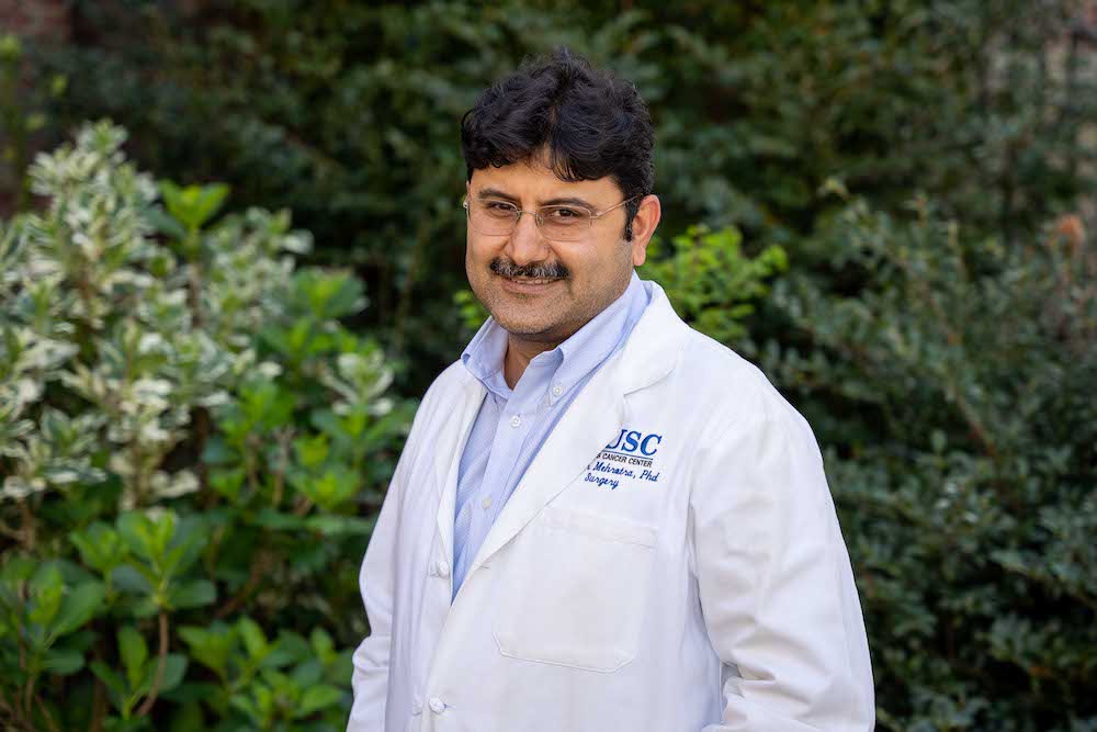 MUSC cancer researcher  Shikhar Mehrotra, Ph.D., standing in a garden.