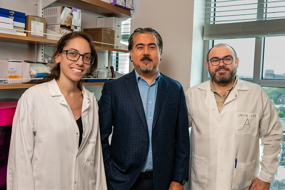 group shot of three cancer scientists in a lab at Hollings Cancer Center