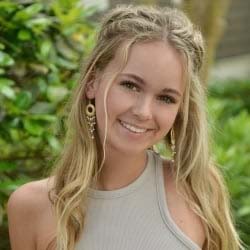 Young blonde woman smiles in headshot.