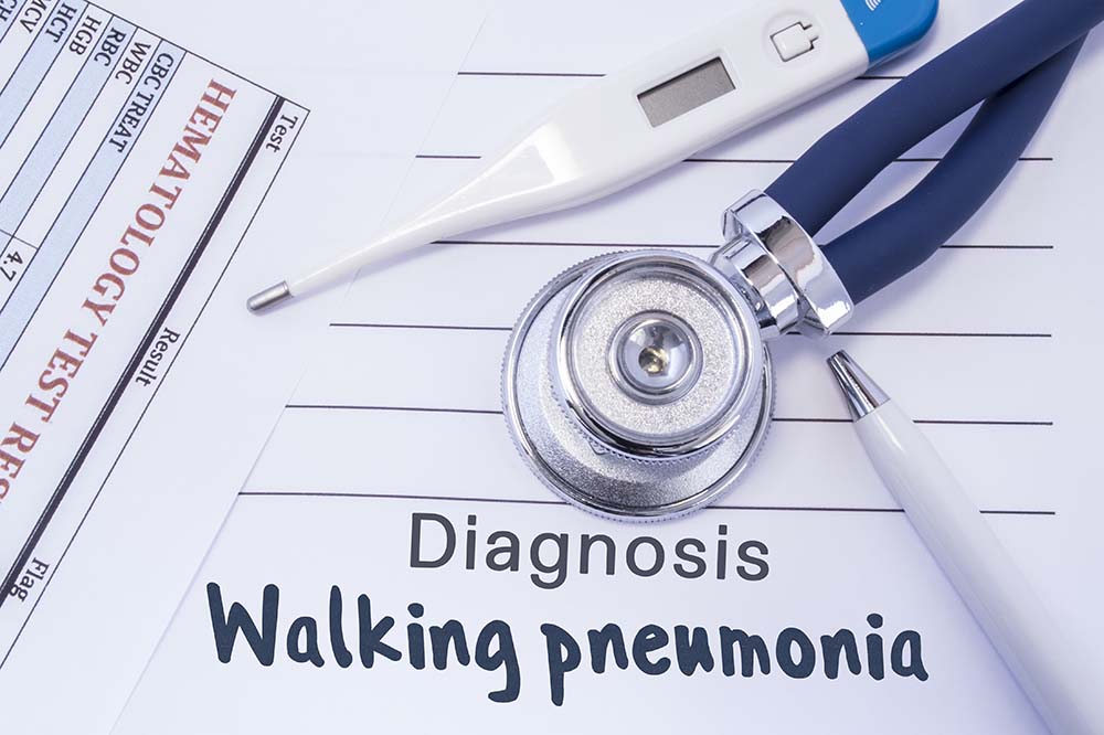 Illustration. Thermometer, stethoscope on paper that says diagnosis walking pneumonia.