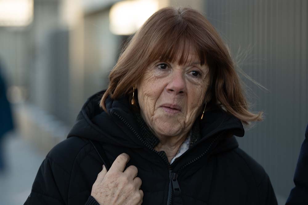 A woman with red hair blowing in the breeze.