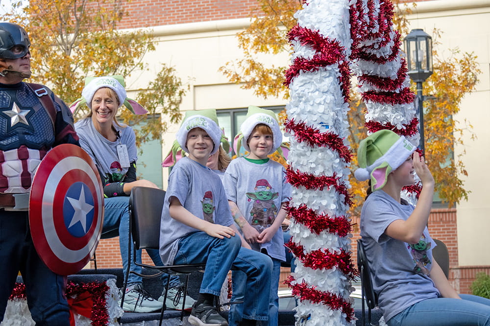 MUSC Angel Tree Parade grand marshal Peter Durst, center, is joined by brother Gabe Jr. and his family aboard a float. Photos by Scott Garrand