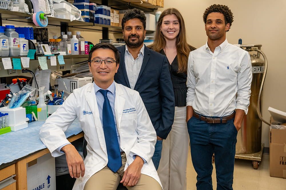 a group of cancer researchers pose in the lab