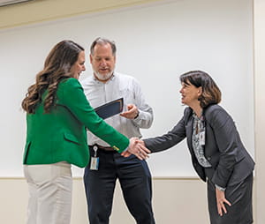 Dr. Julia Hohn receives receives congratulations from Drs. Donna Kern and Paul McDermott.  