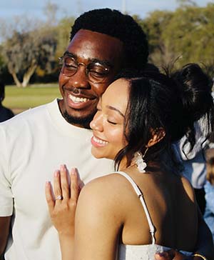 A man and a woman close together smiling
