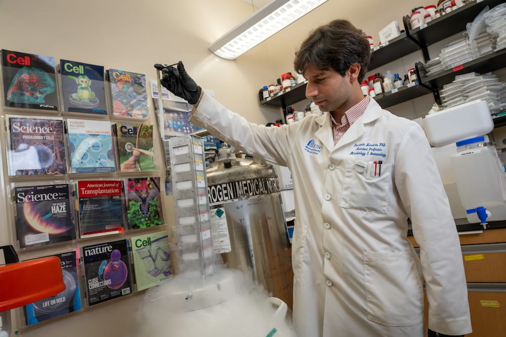 Dr. Leonardo Ferreira extracting patient samples for his study from a liquid nitrogen tank.