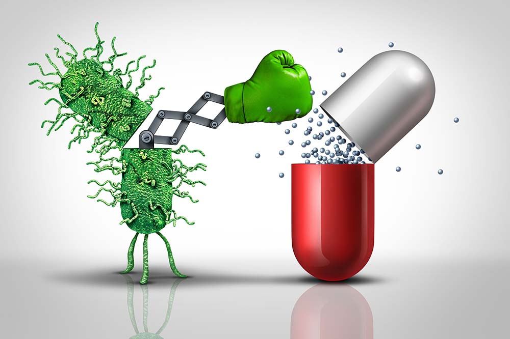 A green figure with a punching glove reaches out and knocks the top off a silver and white pill.
